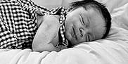 Kohan joined the competition — help win amazing prizes! baby, sleeping, infant, black_and_white, bed, checkered_clothing, soft, peaceful, portrait, newborn, cute, relaxing, closeup, child, face, skin, hair, blanket, comfort, rest