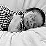 baby, sleeping, infant, black_and_white, bed, checkered_clothing, soft, peaceful, portrait, newborn, cute, relaxing, closeup, child, face, skin, hair, blanket, comfort, rest