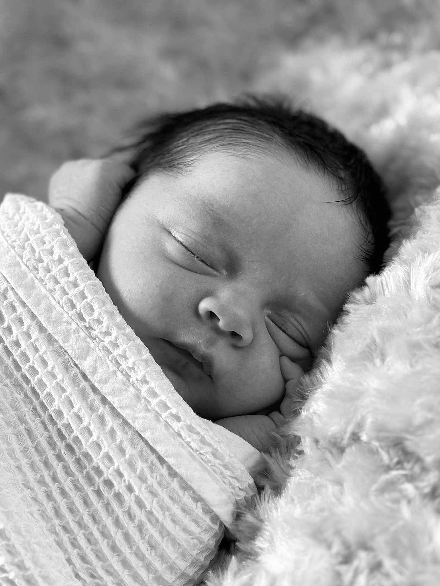 Kohan is registered to the contest to win money with this photo: baby, newborn, sleeping, blanket, swaddled, infant, black_and_white, soft_texture, closeup, portrait, peaceful, cuddly, face, head, hand, cozy, rest, cute, toddler, homedecor