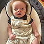 Kohan joined the competition — help win amazing prizes! baby, child, infant, romper, clothing, hair, face, eyes, seat, cushion, palm_tree, dinosaur, hand, legs, furniture, indoors, cute, expression, person, portrait