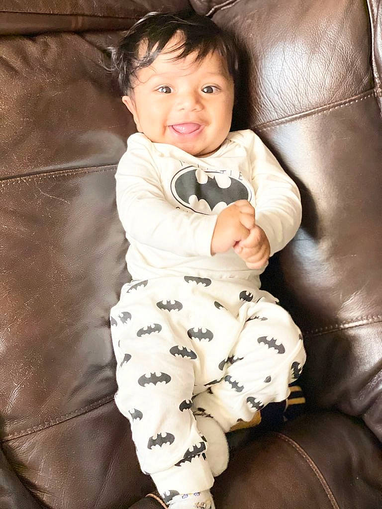 Ishaan is registered to the contest to win money with this photo: baby, baby_toddler_clothing, child, comfort, cool, couch, eye, face, facial_expression, flash_photography, happy, head, human_leg, person, sitting, skin, sleeve, smile, textile, thigh