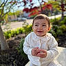 toddler, child, smiling, white_sweater, outdoor, nature, greenery, red_leaves, sunlight, happy, cute, portrait, sitting, young_child, clothing, face, baby, daylight, trees, background_blur