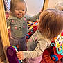 Lorelai Rain joined the competition — help win amazing prizes! toddler, child, mirror, reflection, toy, phone, gray_sweater, cat_face, purple_pants, barefoot, carpet, indoor, laundry_basket, smiling, happy, playing, furniture, room, person, home