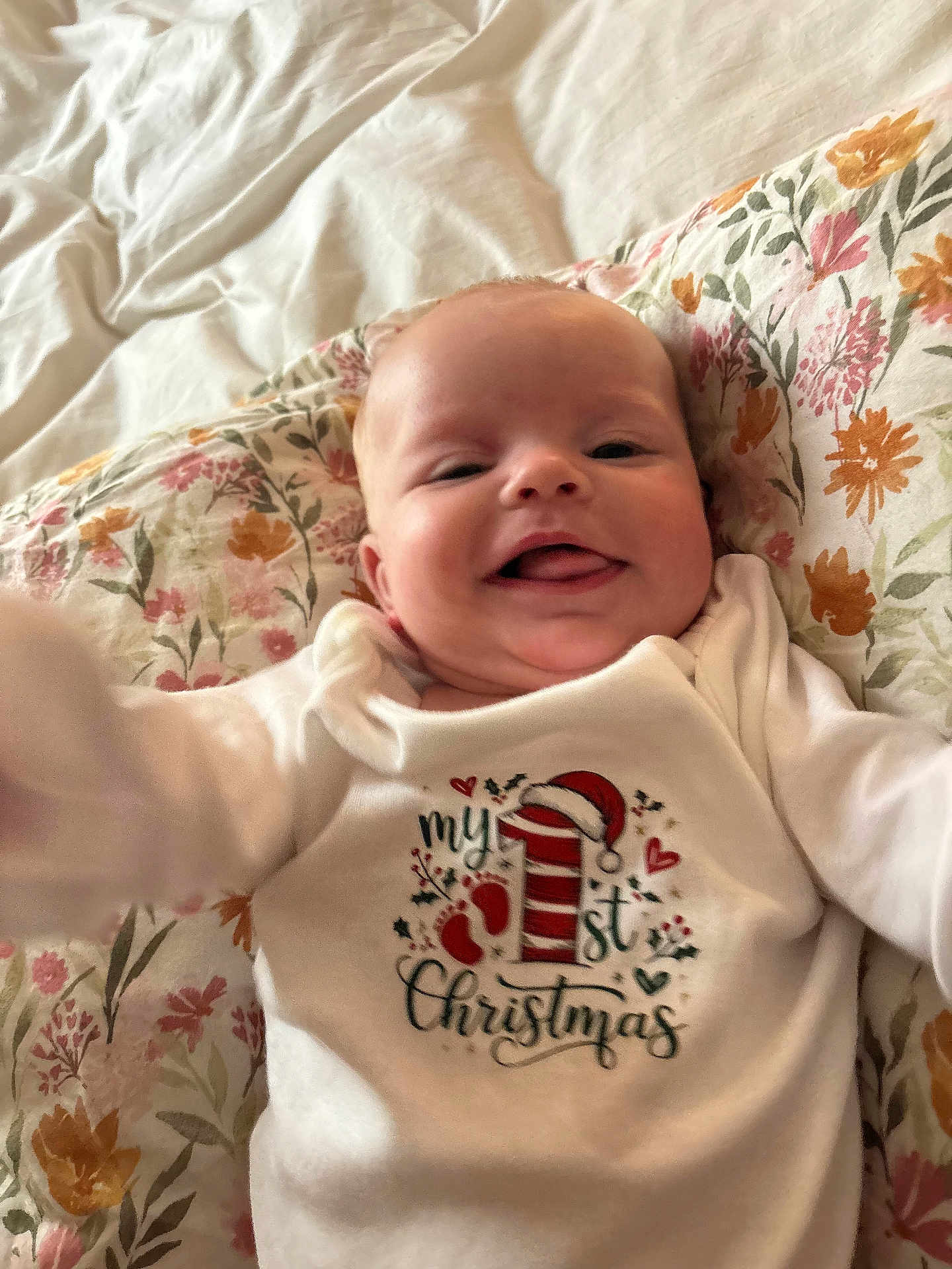 Charity Sky joined the competition — help win amazing prizes! baby, blanket, celebration, child, christmas, clothing, cute, face, floral, happy, head, holiday, indoors, infant, lying_down, onesie, pillow, portrait, skin, smiling