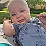 baby, child, infant, outdoor, smile, face, shirt, pattern, pillow, grass, tree, sky, sunlight, cheeks, hand, blue, green, nature, portrait, cute