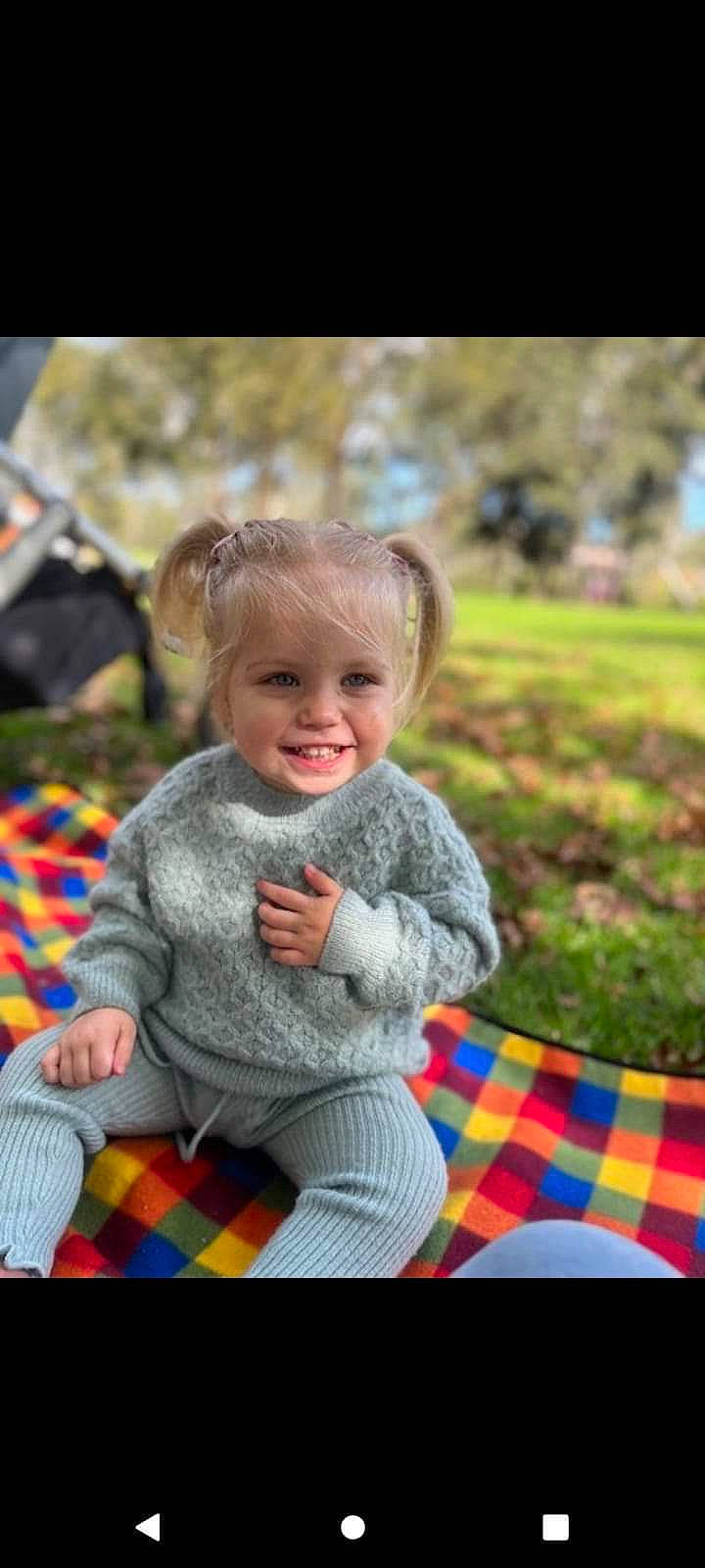 Poppie is registered to the contest to win money with this photo: baby, child, fun, grass, green, happy, joy, leisure, pattern, people_in_nature, person, photograph, plaid, play, recreation, sitting, smile, snapshot, tartan, textile