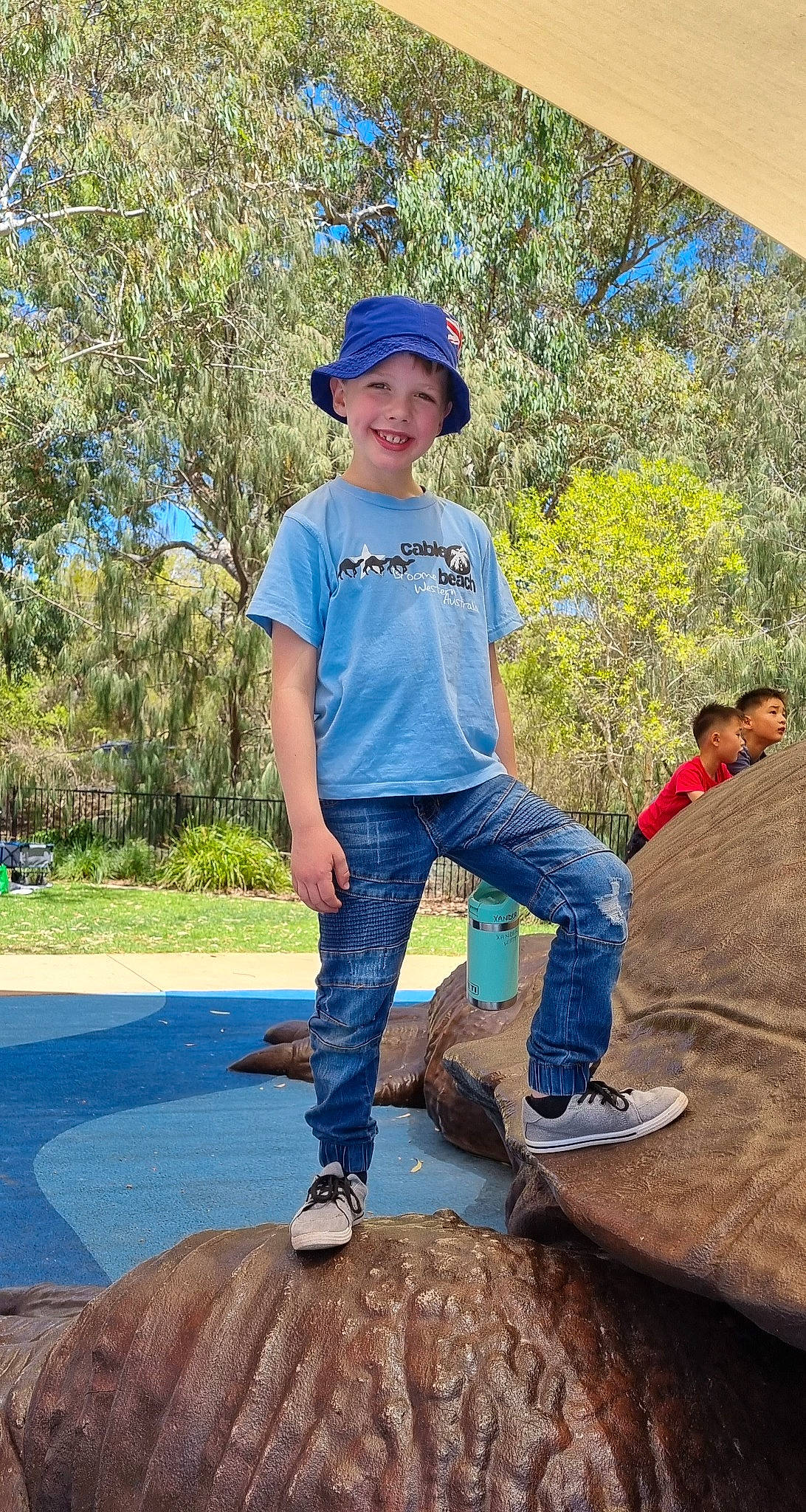 Xander is registered to the contest to win money with this photo: baseball_cap, blue, cap, denim, electric_blue, grass, happy, headwear, jeans, joy, landscape, leaf, leisure, outdoor_shoe, people_in_nature, person, plant, recreation, shoe, sneakers