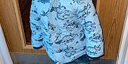 Kayden joined the competition — help win amazing prizes! child, toddler, jacket, beanie, hat, dinosaur_pattern, white_shoes, sneakers, doormat, door, wooden_door, floor, carpet, smiling, standing, clothing, indoor, person, cute, happy