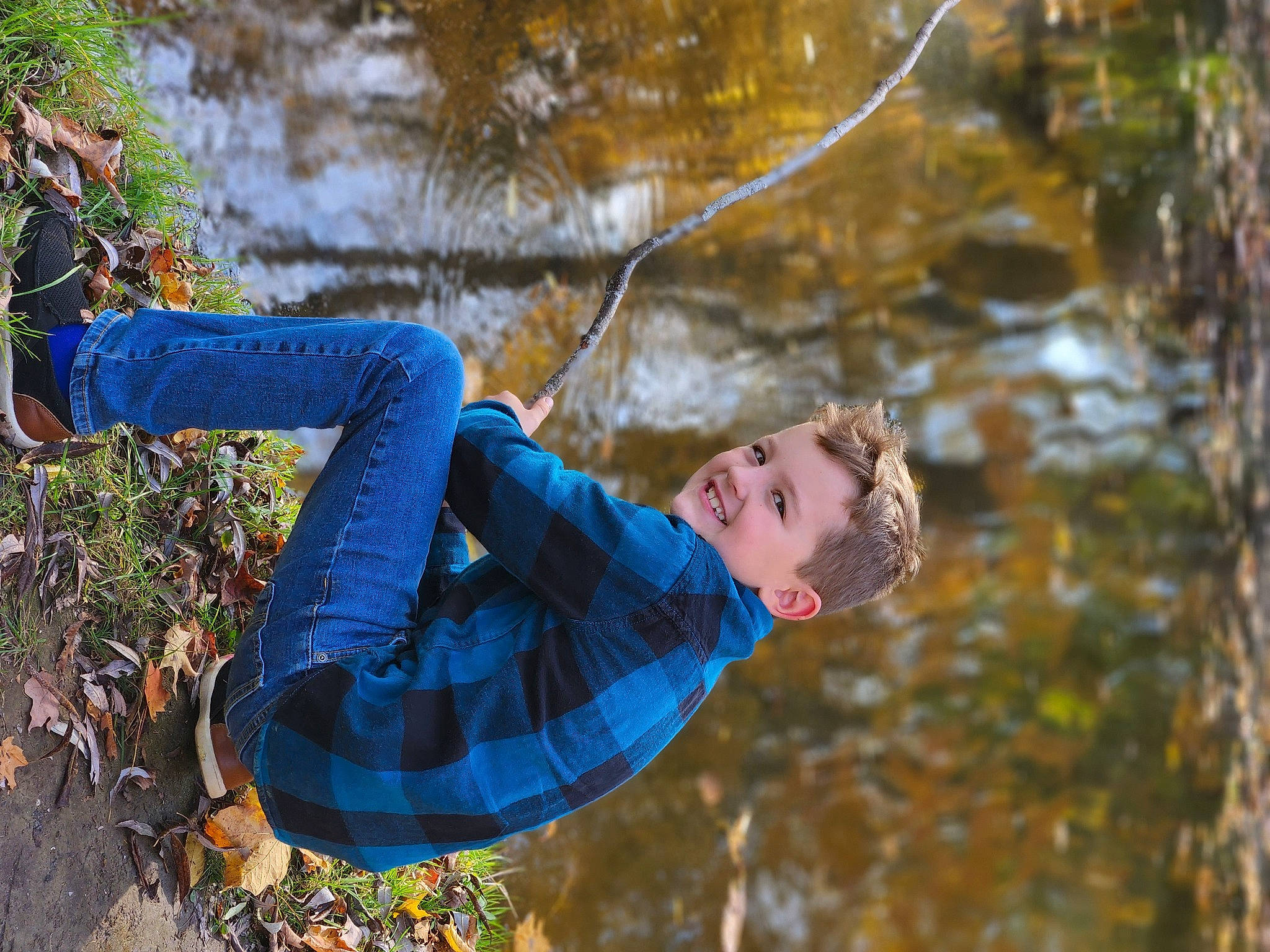 Liam is registered to the contest to win money with this photo: adventure, branch, electric_blue, forest, fun, grass, happy, joy, leisure, natural_environment, people_in_nature, person, plant, recreation, tree, trunk, twig, water, winter, wood