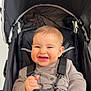 baby, infant, stroller, canopy, harness, buckle, smile, teeth, hands, clothing, onesie, seat, portrait, closeup, happy, straps, baby_face, young_child, indoor, cozy
