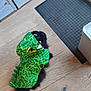 Luna participe au concours pour gagner de l'argent avec cette photo : animal, black_cat, cat, costume, curious, cute, dinosaur_costume, door, eyes, feline, fur, green, house, indoor, looking_up, mat, pet, playful, tail, wooden_floor