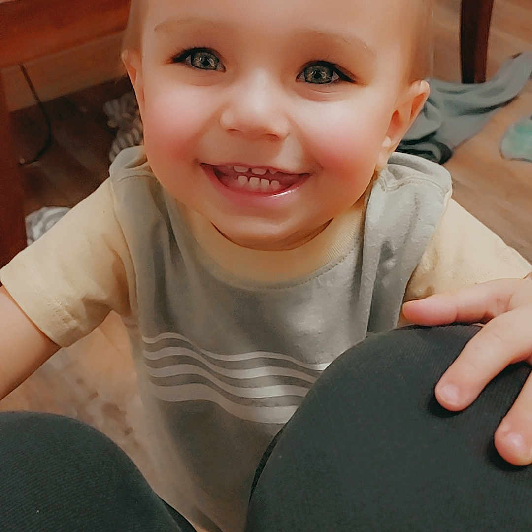 Jaxson joined the competition — help win amazing prizes! toddler, child, smiling, happy, indoor, person, face, eyes, short_hair, clothing, knees, hand, floor, table, furniture, wood, casual, cute, playful, young