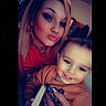Jaxson joined the competition — help win amazing prizes! woman, toddler, indoor, selfie, smile, face, person, makeup, child, holding, red_clothing, brown_clothing, happy, portrait, hair, hand, jewelry, earrings, tattoo, nose_ring