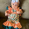 Anslee is registered to the contest to win money with this photo: baby, child, infant, portrait, sitting, couch, bow, hair_accessory, dress, colorful_clothing, ruffles, floral_pattern, animal_graphic, bare_feet, indoors, furniture, happy, wide_eyed, photography, adorable
