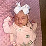 Anslee is registered to the contest to win money with this photo: baby, sleeping, pink, overalls, bow, headband, blanket, infant, child, clothing, soft_texture, cute, peaceful, portrait, toddler, resting, fabric, indoor, person, newborn