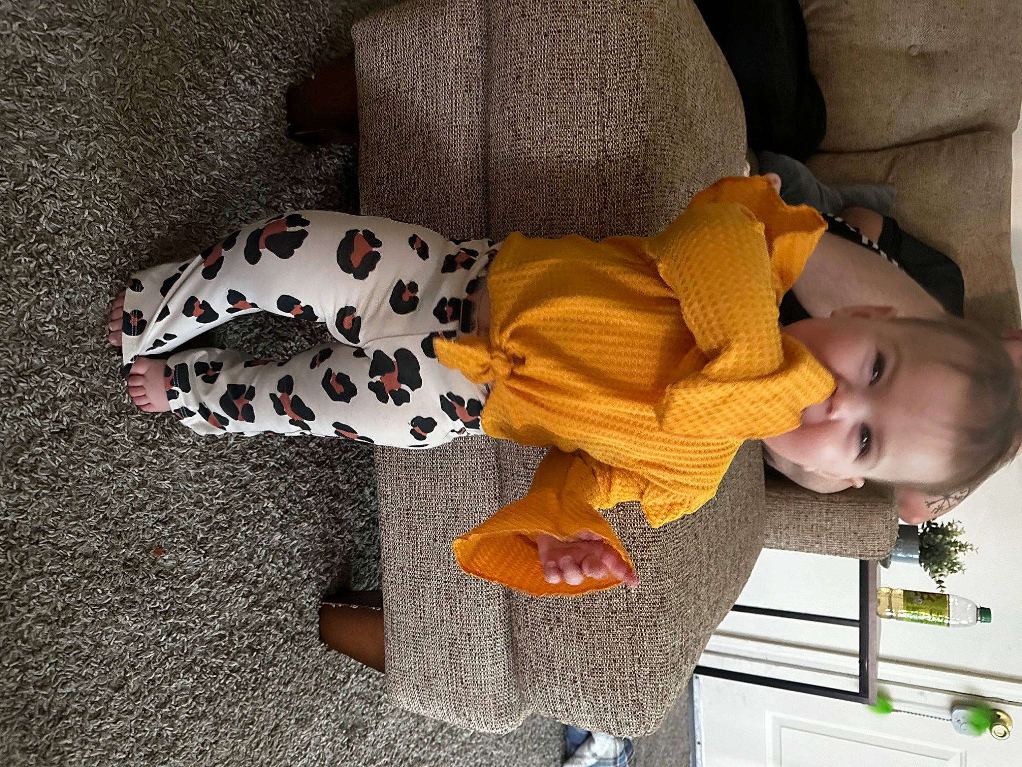 Olivia is registered to the contest to win money with this photo: baby, baby_toddler_clothing, carmine, child, comfort, companion_dog, flooring, fun, linens, pattern, person, room, sitting, toddler, wood