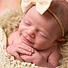 newborn, baby, infant, sleeping, smiling, portrait, close_up, face, headband, bow, hands, blanket, knitted_blanket, teddy_bear, soft, cozy, pink, indoor, photography, cute
