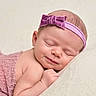 Sophia joined the competition — help win amazing prizes! newborn, baby, sleeping, portrait, close_up, face, headband, purple, bow, blanket, cushion, soft, peaceful, indoors, infant, curled_up, hands, skin, smiling, photography