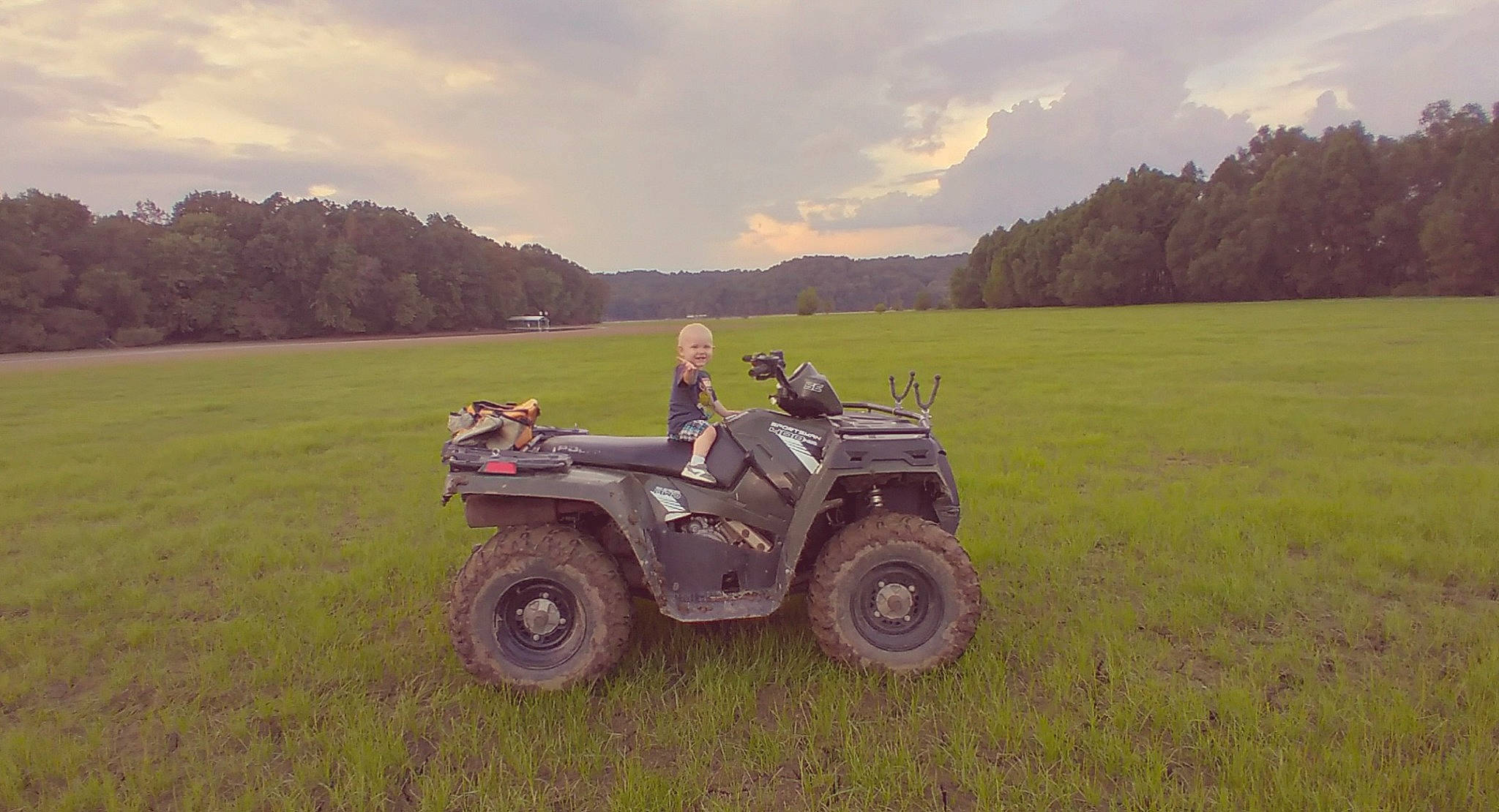 Jackie is registered to the contest to win money with this photo: all_terrain_vehicle, automotive_design, automotive_tire, automotive_wheel_system, cloud, fender, grass, grassland, joy, landscape, meadow, motor_vehicle, person, plain, plant, rolling, sky, tire, tread, tree