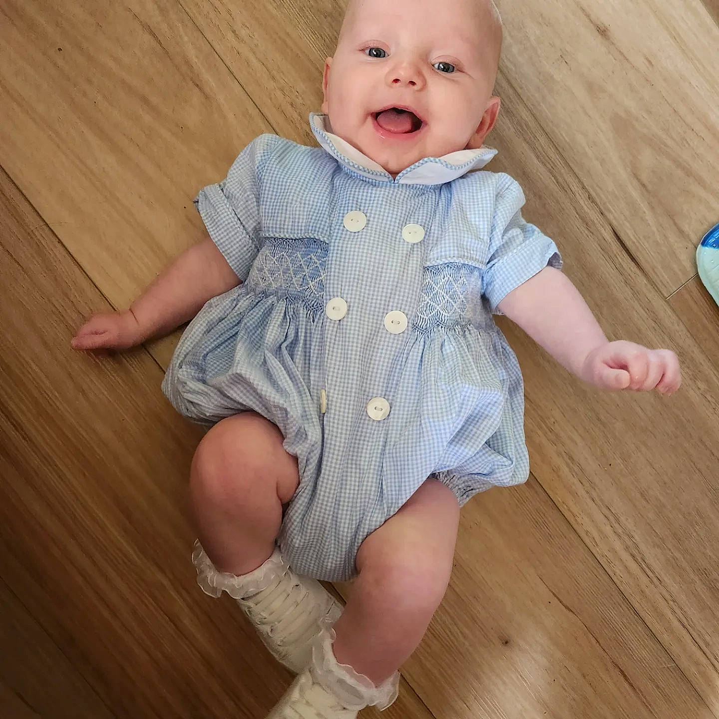 Charlie joined the competition — help win amazing prizes! baby, baby_toddler_clothing, blond, cheek, collar, dress, face, finger, floor, flooring, happy, hardwood, head, iris, pattern, person, skin, sleeve, smile, toddler