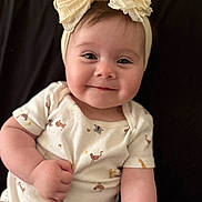 Marlee joined the competition — help win amazing prizes! baby, infant, smile, headband, bow, onesie, animal_print, cute, child, portrait, happy, skin, face, hand, arm, lying_down, clothing, indoors, person, baby_girl