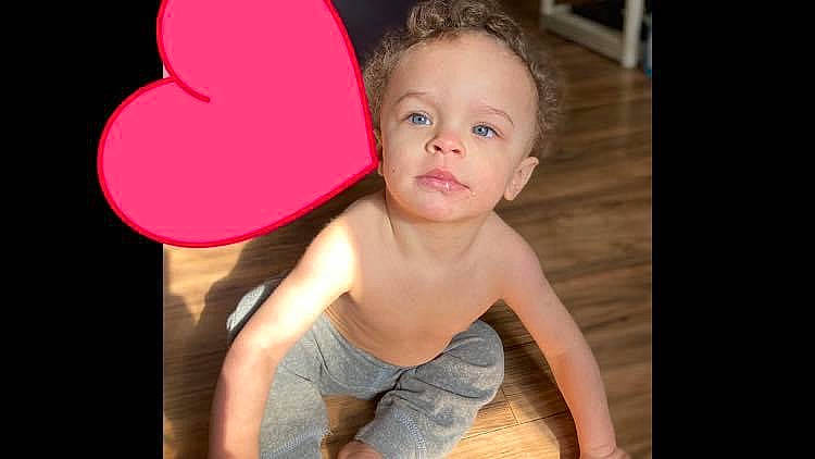 Denzel is registered to the contest to win money with this photo: arm, baby, baby_toddler_clothing, cheek, chest, chin, eyelash, flash_photography, fun, hair, happy, human_body, lip, magenta, neck, nose, person, shorts, sitting, t_shirt
