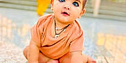 Erika joined the competition — help win amazing prizes! baby, child, crawling, floor, curious_eyes, peach_clothing, bracelet, indoors, blurred_background, person, cute, young_child, portrait, skin, hands, feet, jewelry, bright, daylight, expression