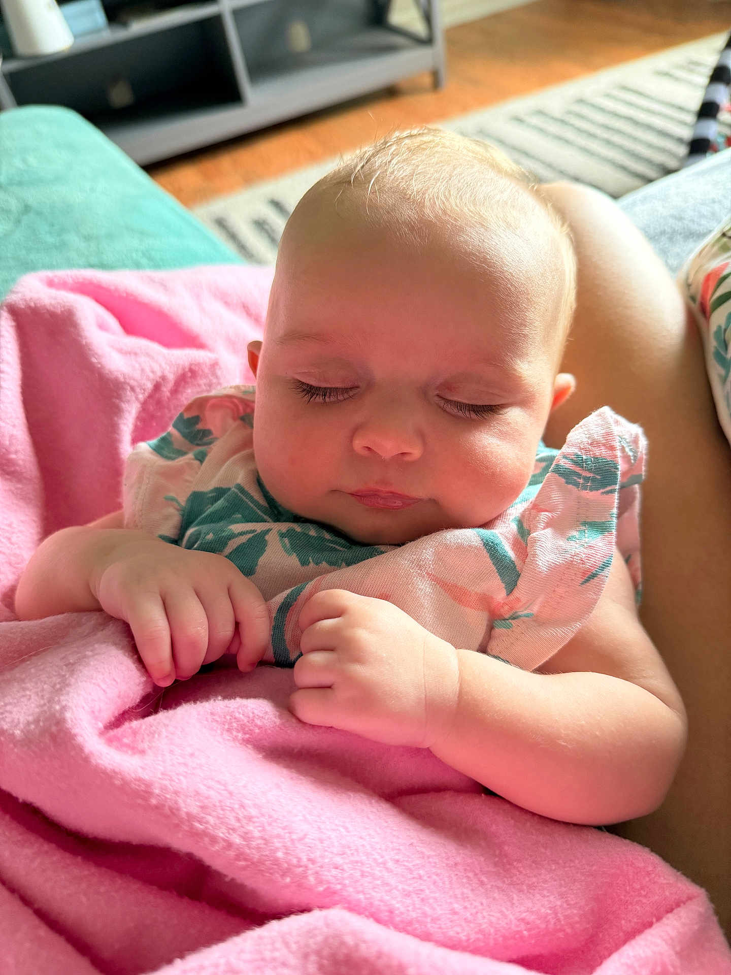 Emery is registered to the contest to win money with this photo: baby, sleeping, blanket, pink, infant, hands, face, closed_eyes, soft_light, home_interior, couch, comfort, peaceful, child, person, portrait, cute, resting, cozy, clothing