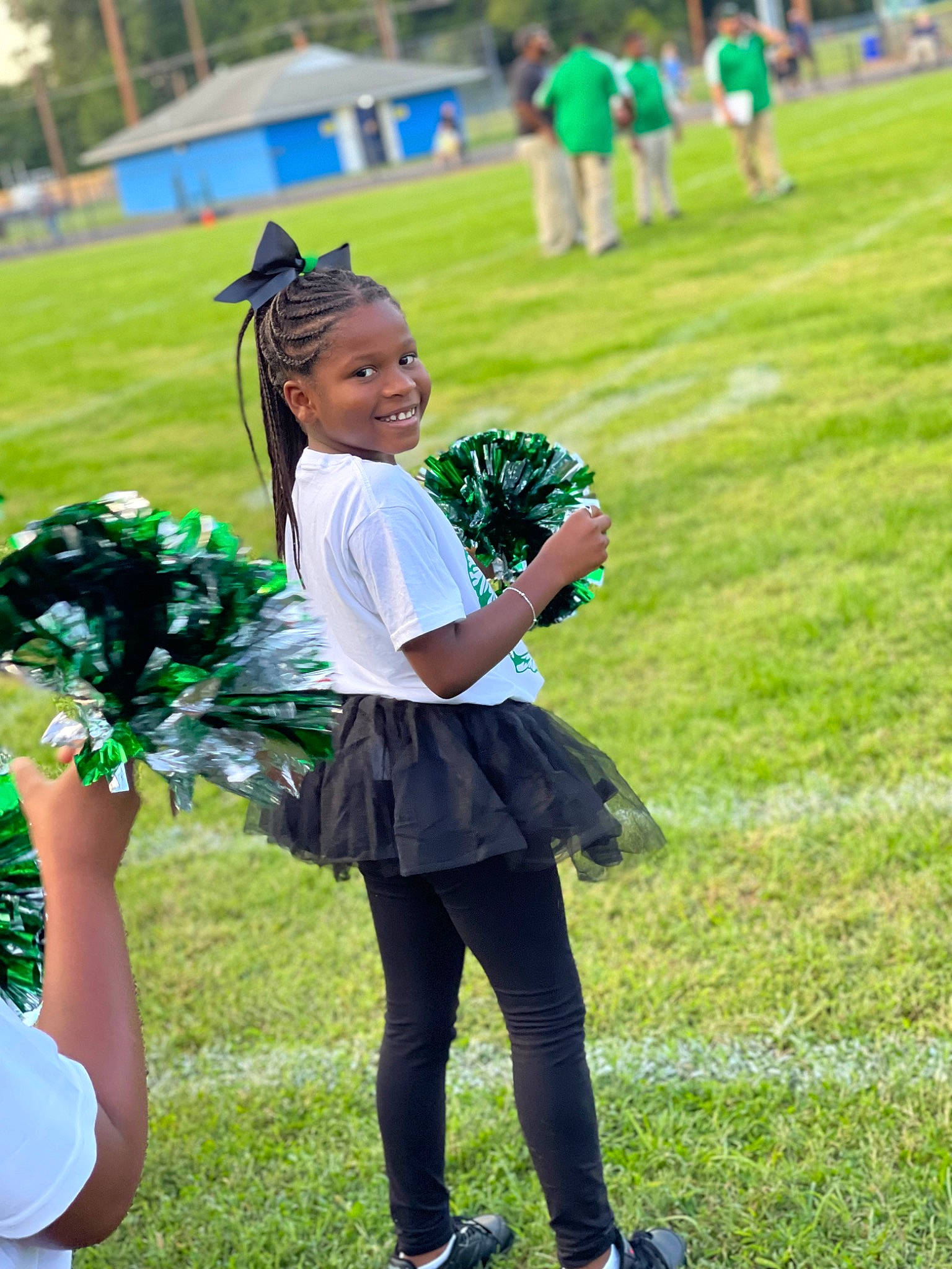 Starr is registered to the contest to win money with this photo: blue, championship, cheerleading_uniform, dance, dress, entertainment, facial_expression, grass, green, hairstyle, happy, joy, performing_arts, person, plant, player, recreation, smile, sneakers, sports