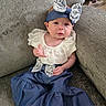 baby, infant, child, blue_outfit, bow, headband, white_lace, couch, furniture, sitting, cute, expression, indoors, sock, portrait, young_child, fabric, clothing, person, comfortable