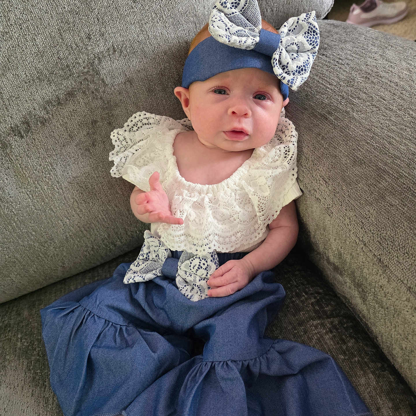 Rayne joined the competition — help win amazing prizes! baby, infant, child, blue_outfit, bow, headband, white_lace, couch, furniture, sitting, cute, expression, indoors, sock, portrait, young_child, fabric, clothing, person, comfortable
