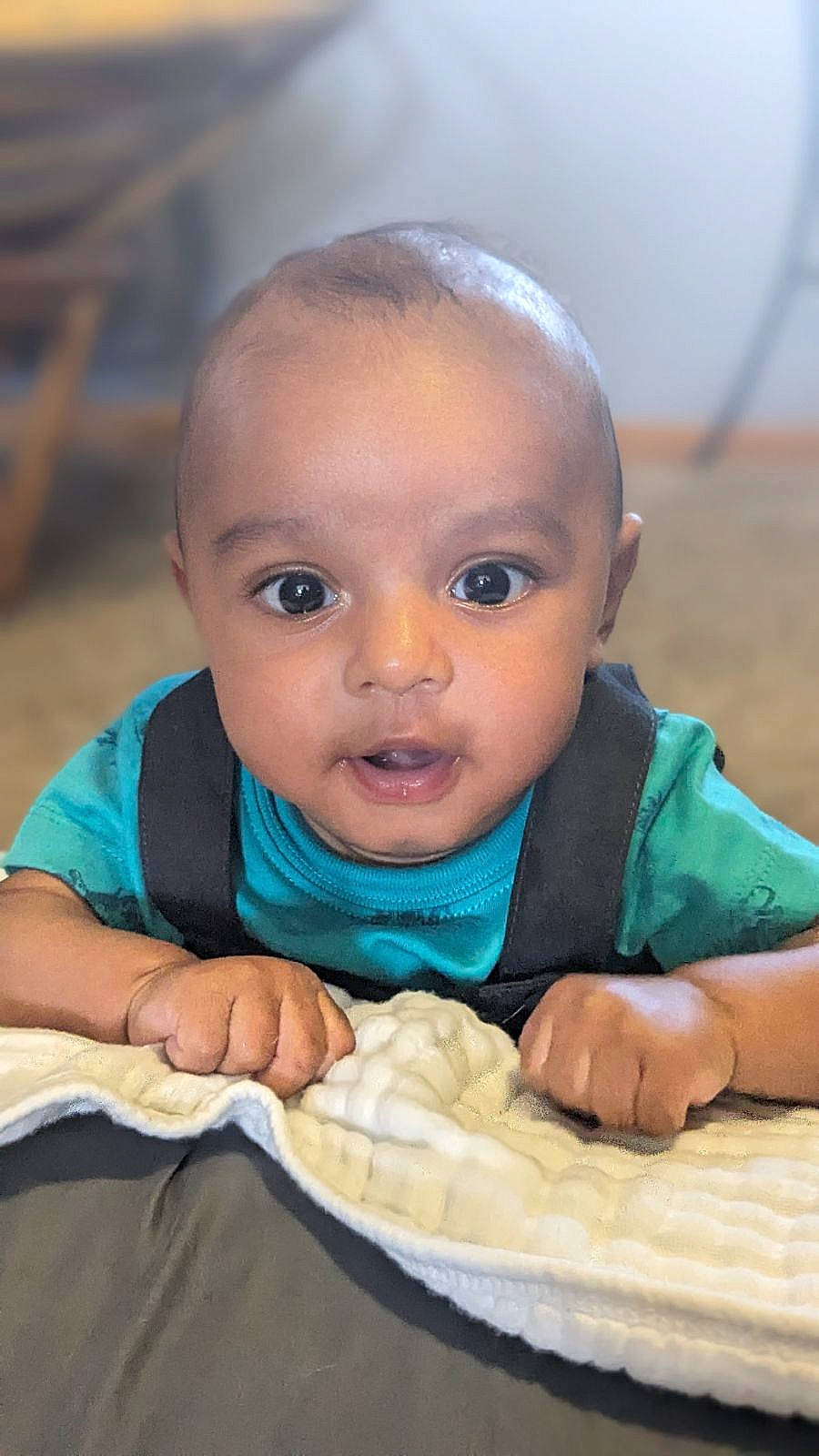 Everett is registered to the contest to win money with this photo: arm, baby, baby_products, baby_toddler_clothing, cheek, child, close_up, finger, fun, gesture, grass, hand, happy, leisure, person, portrait_photography, sitting, skin, thumb, toddler