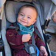 Archer is registered to the contest to win money with this photo: baby, infant, child, smiling, stroller, portrait, outdoor, harness, seated, clothing, jacket, bib, canopy, face, eyes, hands, happy, closeup, daylight,  안전