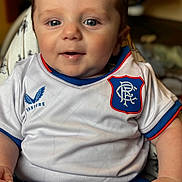 Luca joined the competition — help win amazing prizes! baby, child, infant, smiling, blue_eyes, white_jersey, blue_shorts, sitting, closeup, indoors, cute, portrait, chubby, hand, clothing, soft_lighting, happy, person, baby_fashion, comfortable