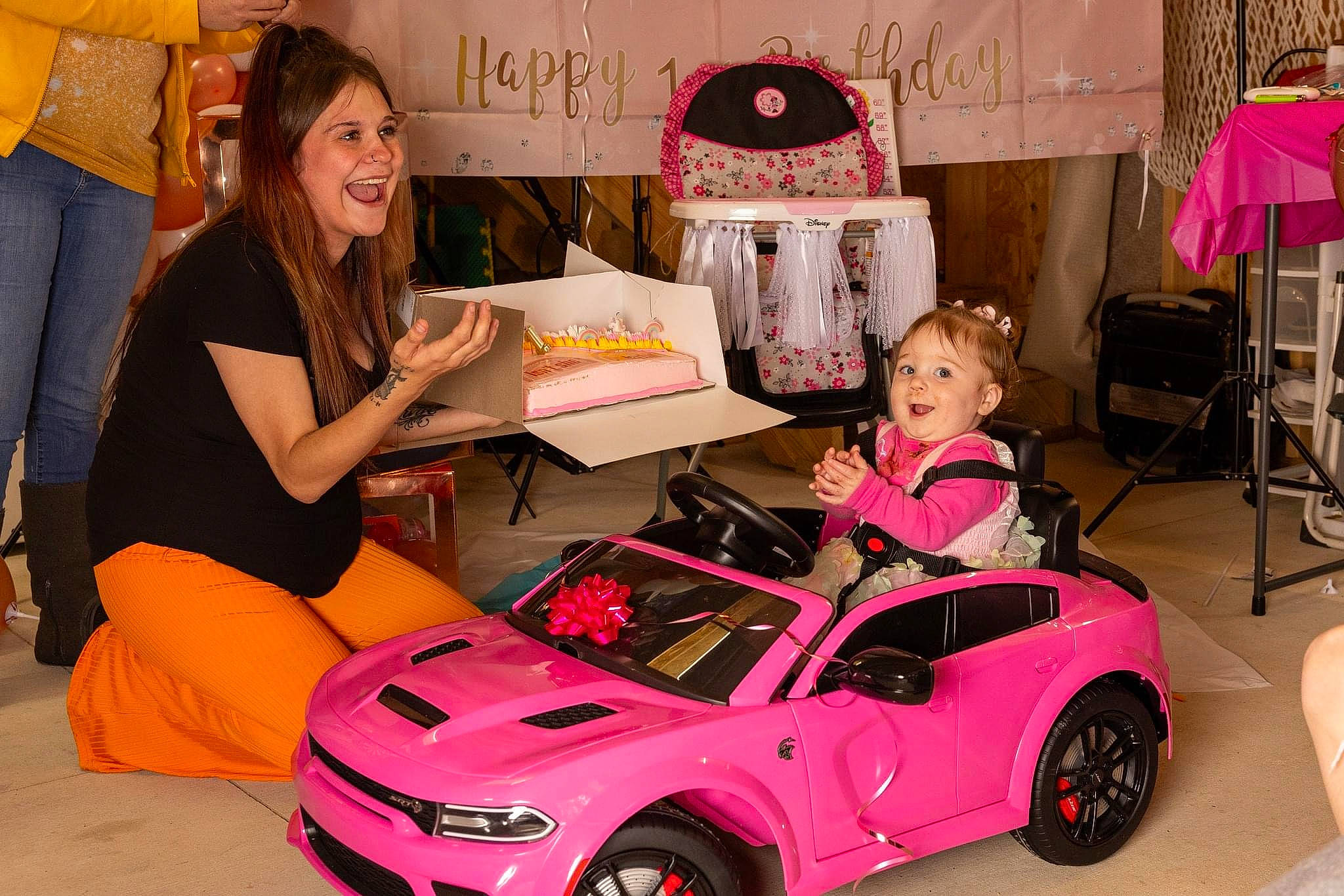 Nelly is registered to the contest to win money with this photo: alloy_wheel, automotive_design, automotive_exterior, automotive_lighting, bumper, car, chair, hood, jeans, joy, motor_vehicle, orange, person, personal_luxury_car, pink, red, rim, smile, tire, vehicle