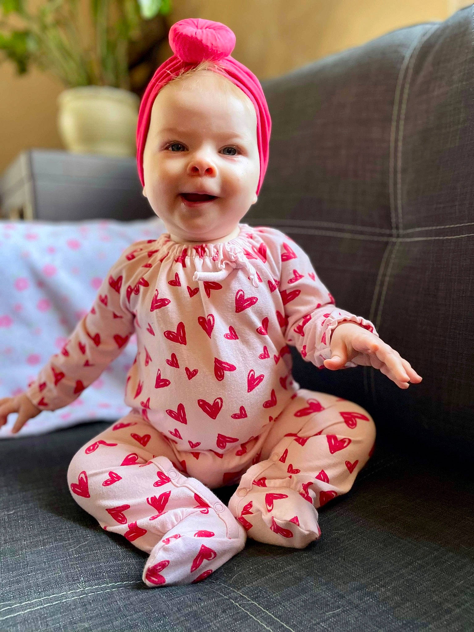 Charlotte joined the competition — help win amazing prizes! baby, baby_toddler_clothing, cap, child, collar, face, flowerpot, happy, head, houseplant, magenta, pattern, person, pink, plant, sitting, skin, sleeve, smile, textile