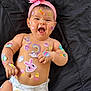 baby, infant, smiling, headband, flower, stickers, easter, diaper, cute, lying_down, happy, colorful, skin, cheeks, arms, hands, background, blanket, playful, festive