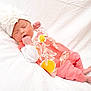 Alice is registered to the contest to win money with this photo: baby, newborn, sleeping, hat, flower_pattern, white_blanket, infant, peaceful, cute, soft_texture, clothing, pink_pants, small_hands, bare_feet, portrait, resting, adorable, child, lying_down, cozy