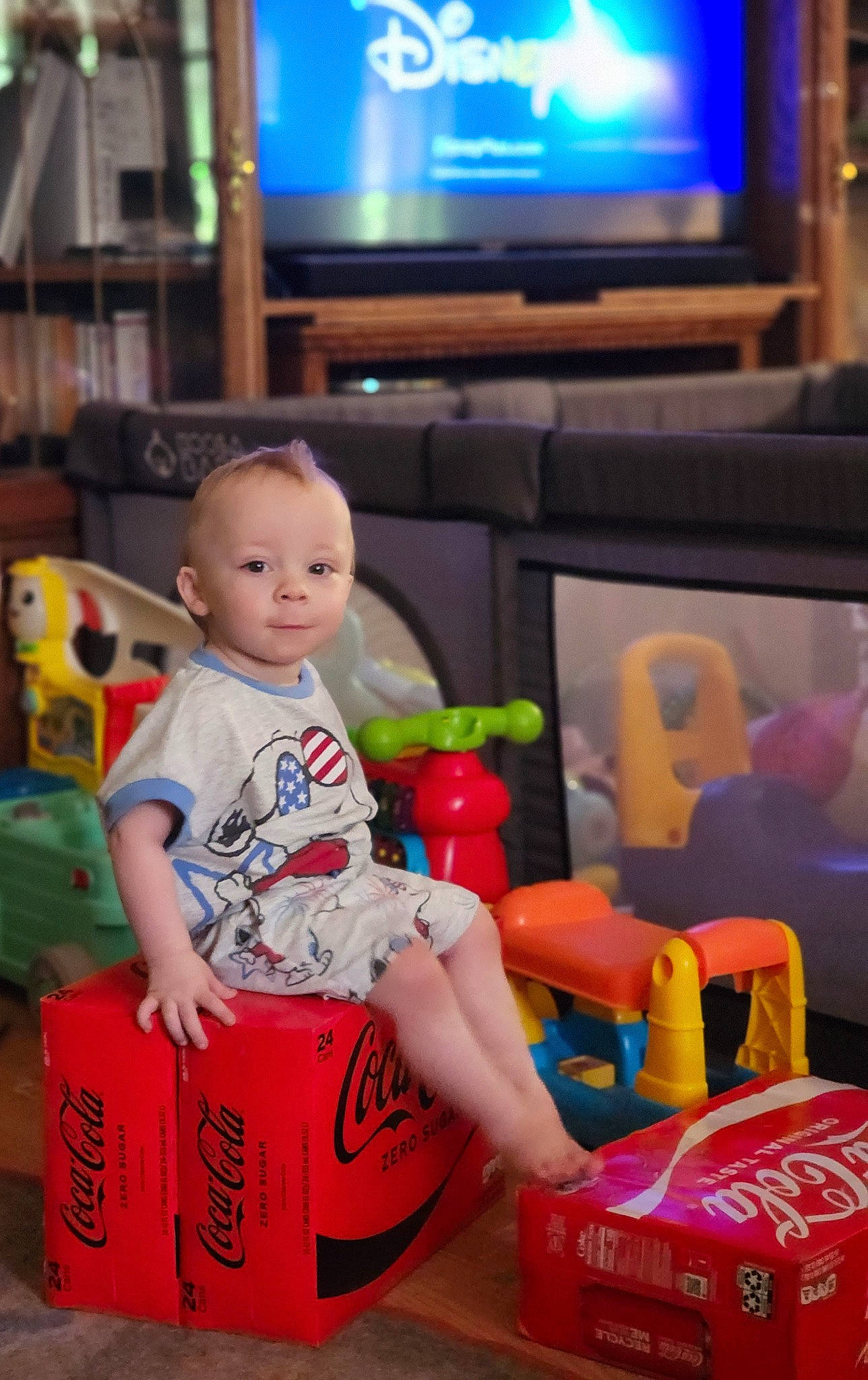 Gunnar is registered to the contest to win money with this photo: baby, baby_toys, box, child, display_device, event, flooring, fun, led_backlit_lcd_display, leisure, person, plastic, play, room, sitting, snapshot, television, television_set, toddler, toy