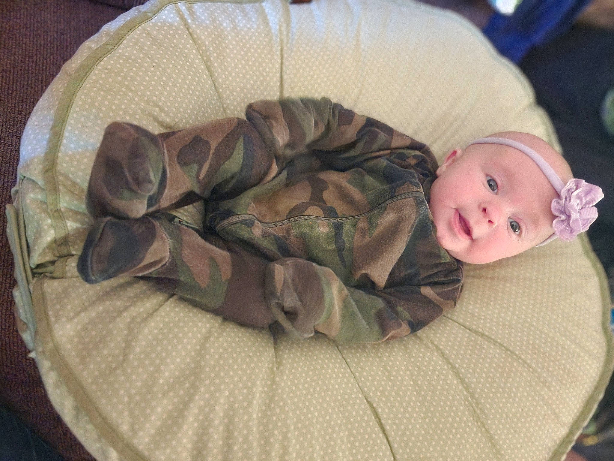 Brenn is registered to the contest to win money with this photo: baby, baby_products, baby_toddler_clothing, camouflage, child, comfort, fashion_accessory, grass, headgear, headwear, linens, military_camouflage, nap, pattern, person, sitting, sleep, sleeve, toddler, tree