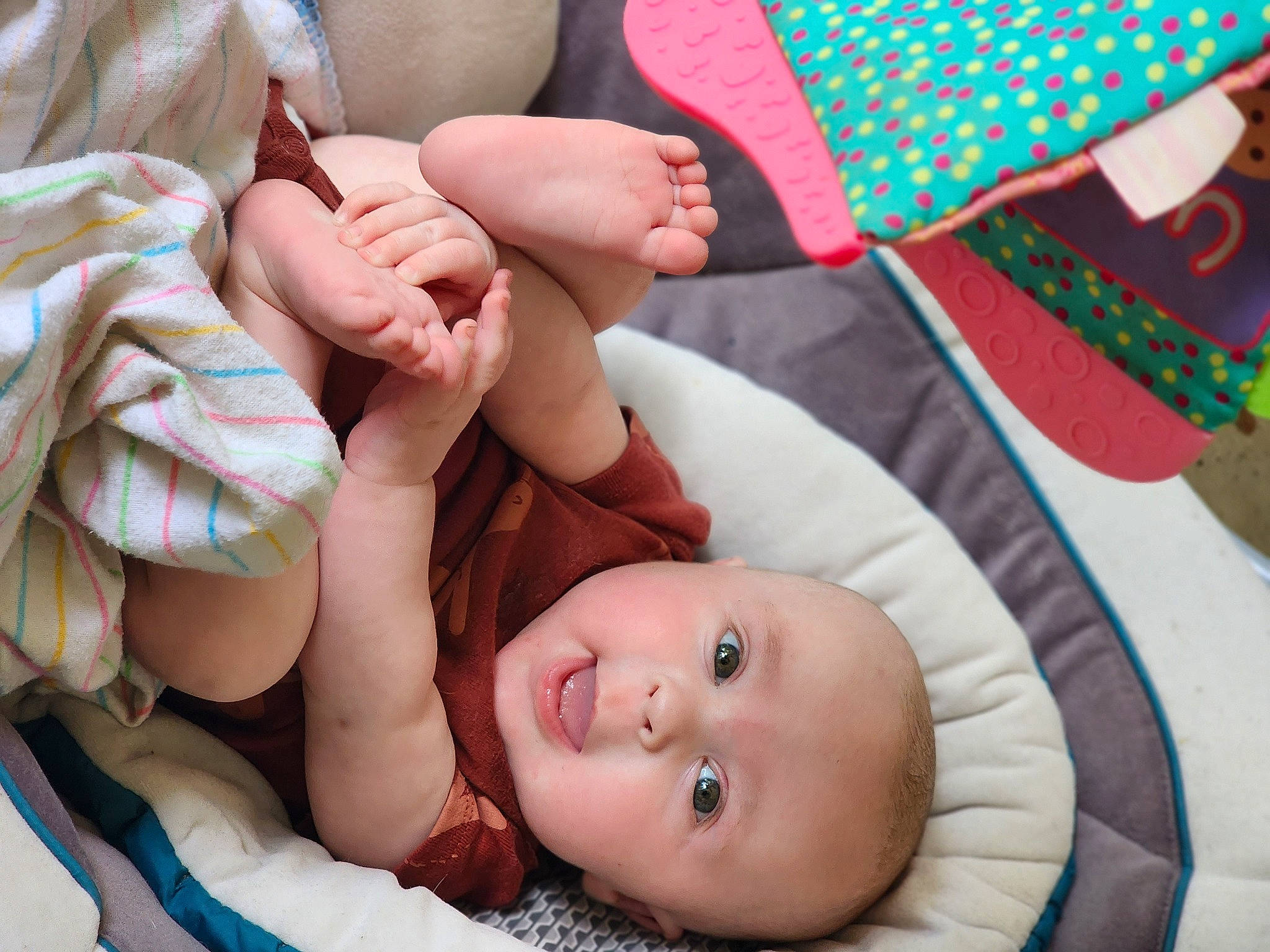 Brenn is registered to the contest to win money with this photo: arm, baby, baby_toddler_clothing, barefoot, cheek, child, comfort, foot, fun, gesture, grass, green, hand, happy, human_body, pattern, person, skin, textile, thumb