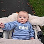 William is registered to the contest to win money with this photo: baby, blue_sweater, stroller, outdoor, grass, path, leaves, child, cozy, autumn, cute, person, infant, casual_clothing, hand, face, wide_eyes, warm, soft_texture, walking