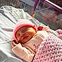 newborn, baby, sleeping, pink_hat, pink_blanket, hospital_bassinet, infant, knitwear, cozy, peaceful, cute, child, portrait, resting, soft_light, indoors, small_hands, blanket, sleep, baby_clothes