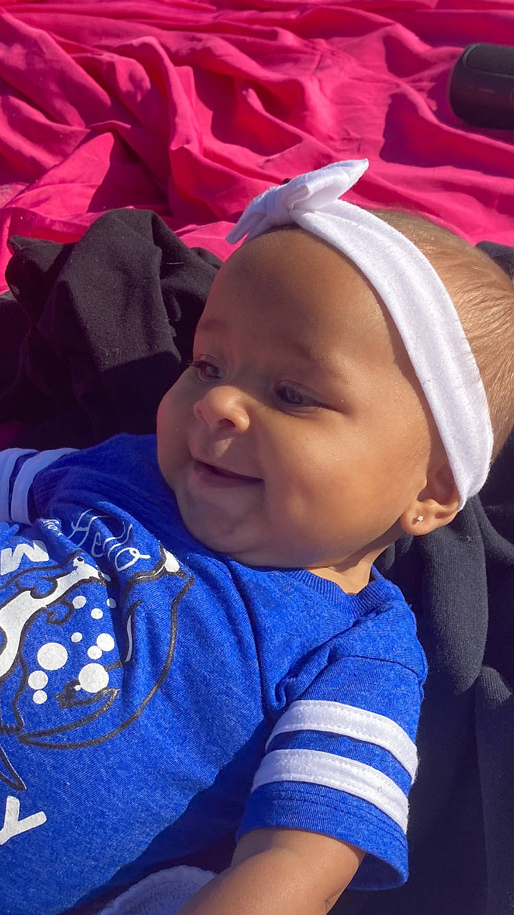 Kailynn is registered to the contest to win money with this photo: baby, baby_toddler_clothing, cheek, child, comfort, cool, facial_expression, happy, headgear, headwear, lip, mouth, outerwear, person, pink, product, purple, skin, smile, textile