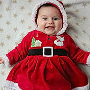 Anaïa participe au concours pour gagner de l'argent avec cette photo : baby, child, smiling, red_clothing, hood, blanket, stars_pattern, face, happy, cute, christmas, holiday, festive, fur_trim, portrait, infant, lying_down, indoors, cozy, warm