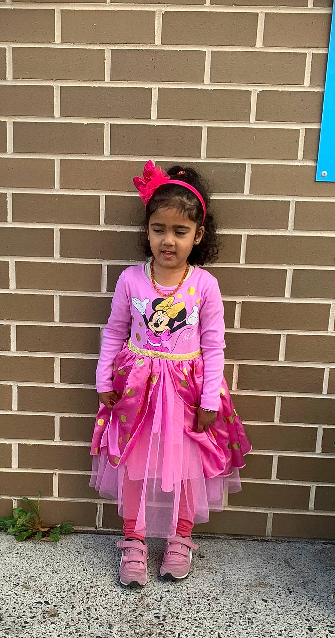 Ishaani is registered to the contest to win money with this photo: baby_toddler_clothing, child, clothing, costume, dress, embellishment, fashion_accessory, fashion_design, happy, headwear, houseplant, jewellery, magenta, pattern, person, pink, plant, purple, ruffle, sleeve