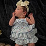 Elowyn joined the competition — help win amazing prizes! baby, child, infant, dress, headband, bow, blanket, lying_down, cute, rosy_cheeks, hand, fingers, blue_dress, floral_pattern, sleepwear, portrait, indoors, soft_texture, peaceful, young