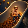 baby, bathtub, carpet, child, clothing, cute, expression, floor, indoor, infant, lighting, playful, portrait, room, rubber_duck, sitting, socks, toy, white, yellow