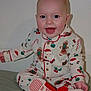 Ellijah is registered to the contest to win money with this photo: baby, child, smiling, pajamas, christmas, holiday, festive, sitting, indoors, cute, happy, slippers, red, white, gingerbread, santa, cozy, portrait, infant, celebration