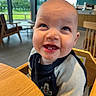baby, cafe, chair, child, cute, face, greenery, happy, high_chair, indoor, infant, long_sleeve, messy_face, person, shirt, smiling, table, teeth, window, wooden_furniture